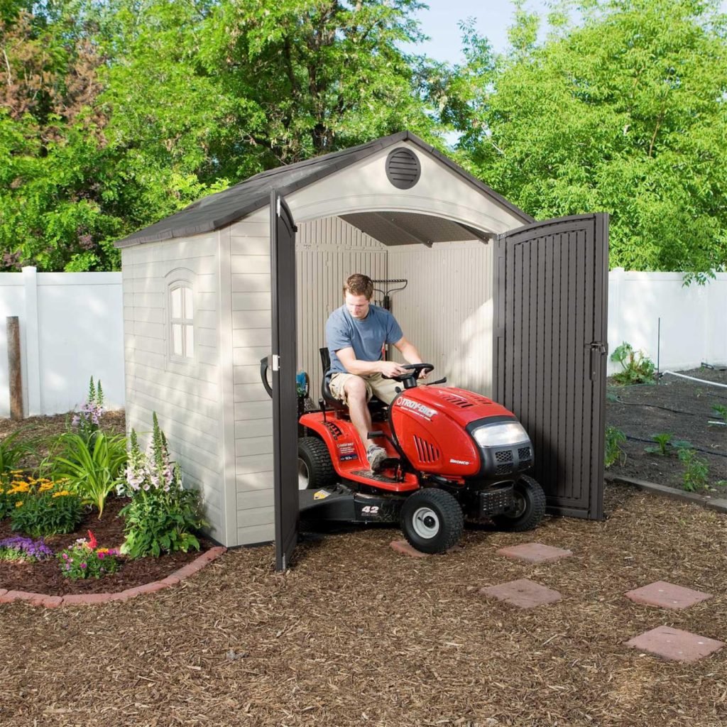 riding lawn mower in storage shed